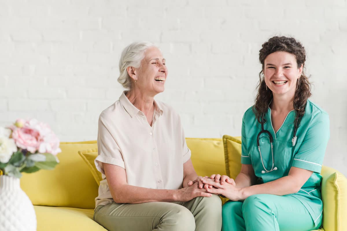 happy nurse senior woman holding hands